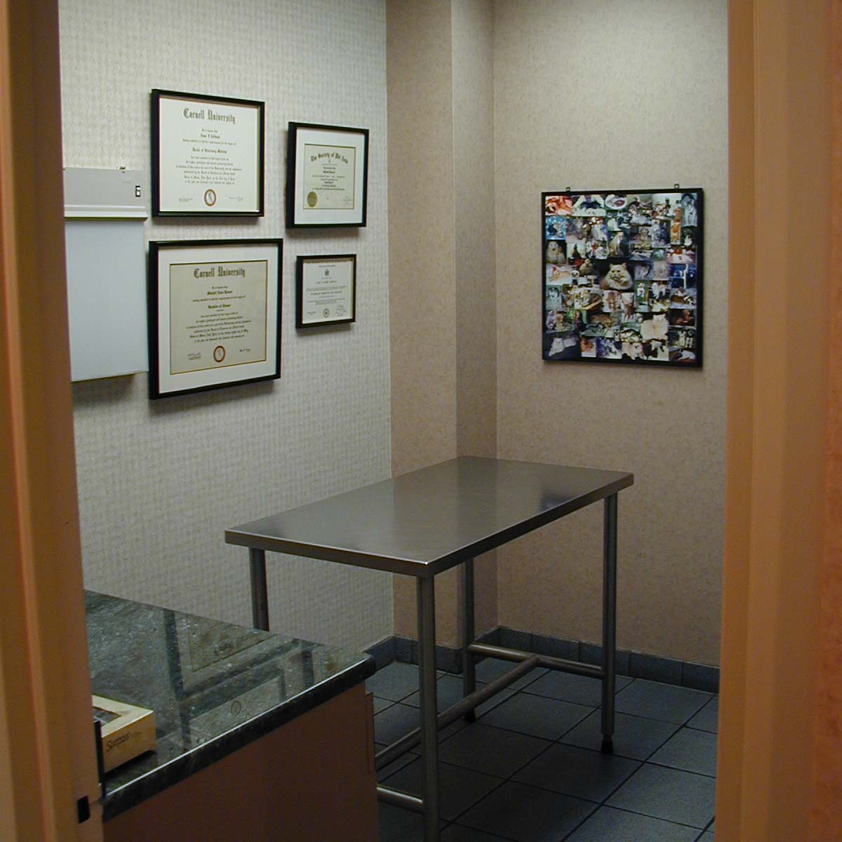 a room with a table and pictures on the wall